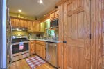 Kitchen with Stainless Electric Appliances and Granite Counter Tops 